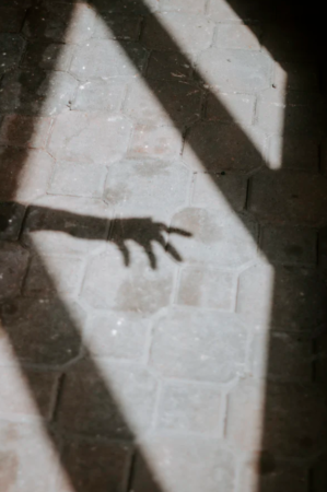 Shadow of a hand reaching out